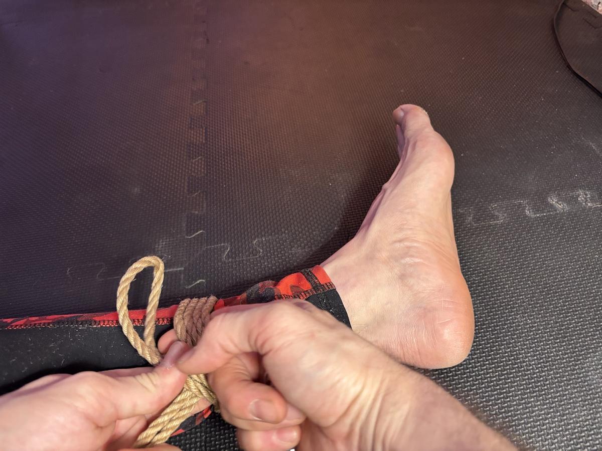 finger hook to grab the bight from the other side (beneath the cuff)